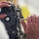 close up of male hands repairing outboard motor